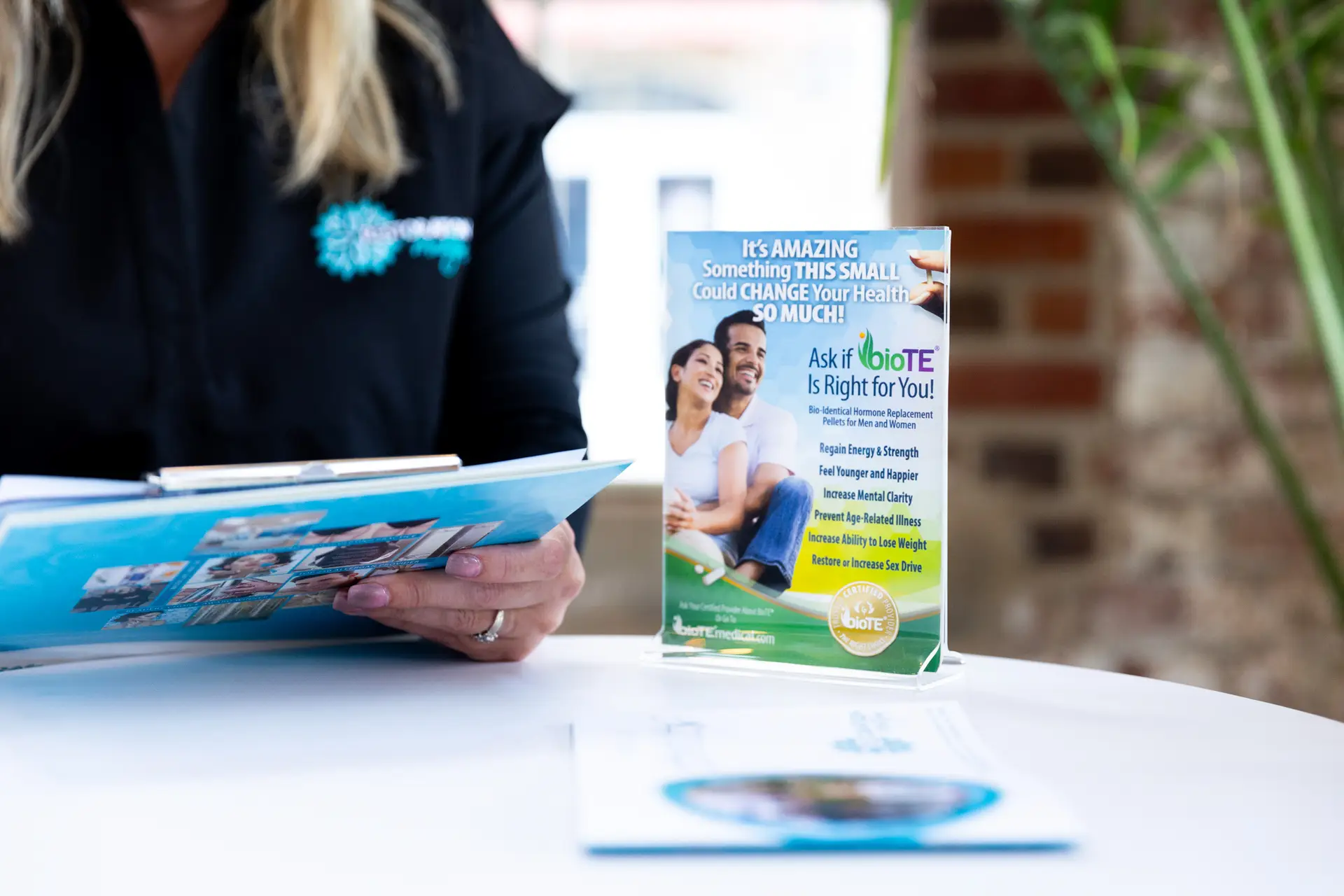 A nurse shows a patient a pamphlet during a consultation for a hormone treatment in Greensboro