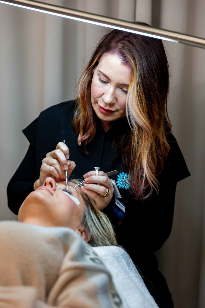 A female esthetician applies a product for lashes treatment in Winston-Salem